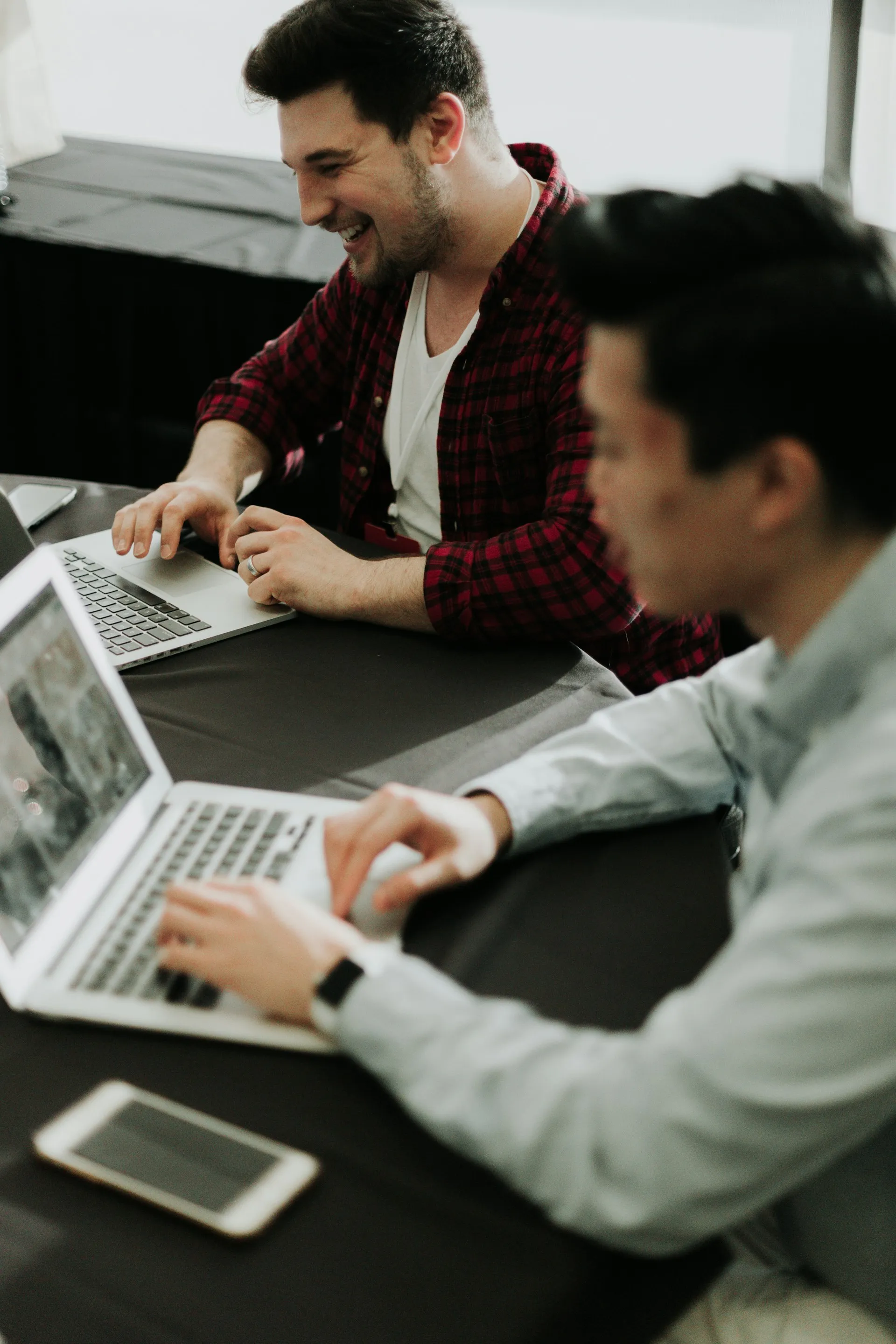 A small business team collaborating around laptops